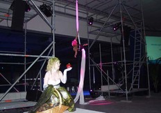 De openingsact: zangeres op de voorgrond zorgde voor muzikale begeleiding en daarachter een acrobatische voorstelling in het lint