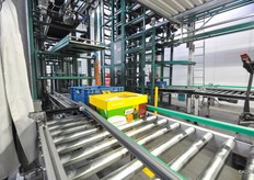 Vervolgens brengt een lift de doos of krat naar de juiste afvoerband. De machine weet aan de hand van de codering op welke van de afvoerbanden de doos terecht moet komen.