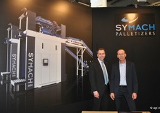 Johnny de Bat en Patrick Gijsel van Symach Palletizers. Op de achtergrond een beeld van de nieuwe generatie palletizers.